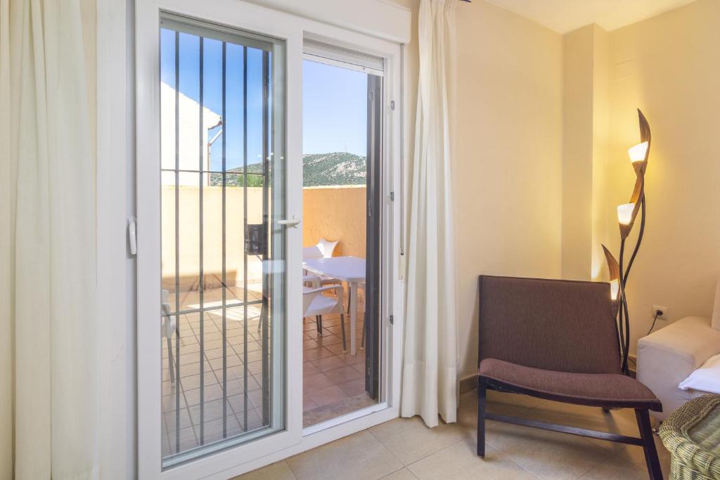 a room with a sliding glass door to a balcony at Zahara Sol Villas y Apartamentos by QHotels in Zahara de los Atunes