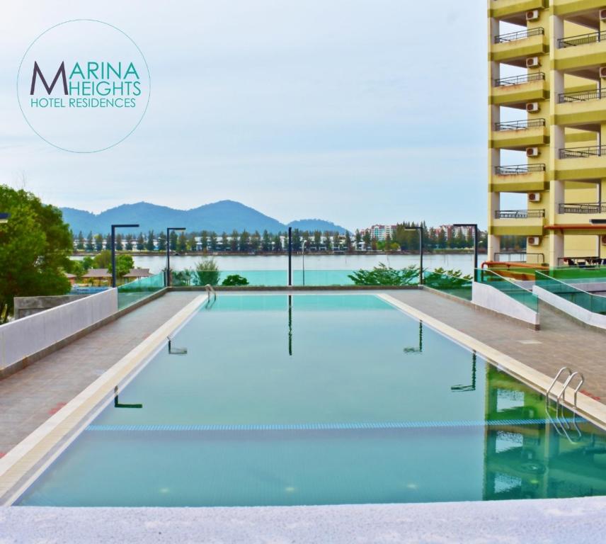 a swimming pool on the roof of a building at Marina Heights Hotel Residences in Lumut