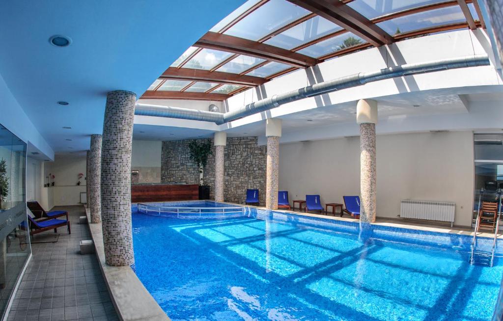 a large swimming pool with a glass ceiling at Predela 2 Aparthotel in Bansko