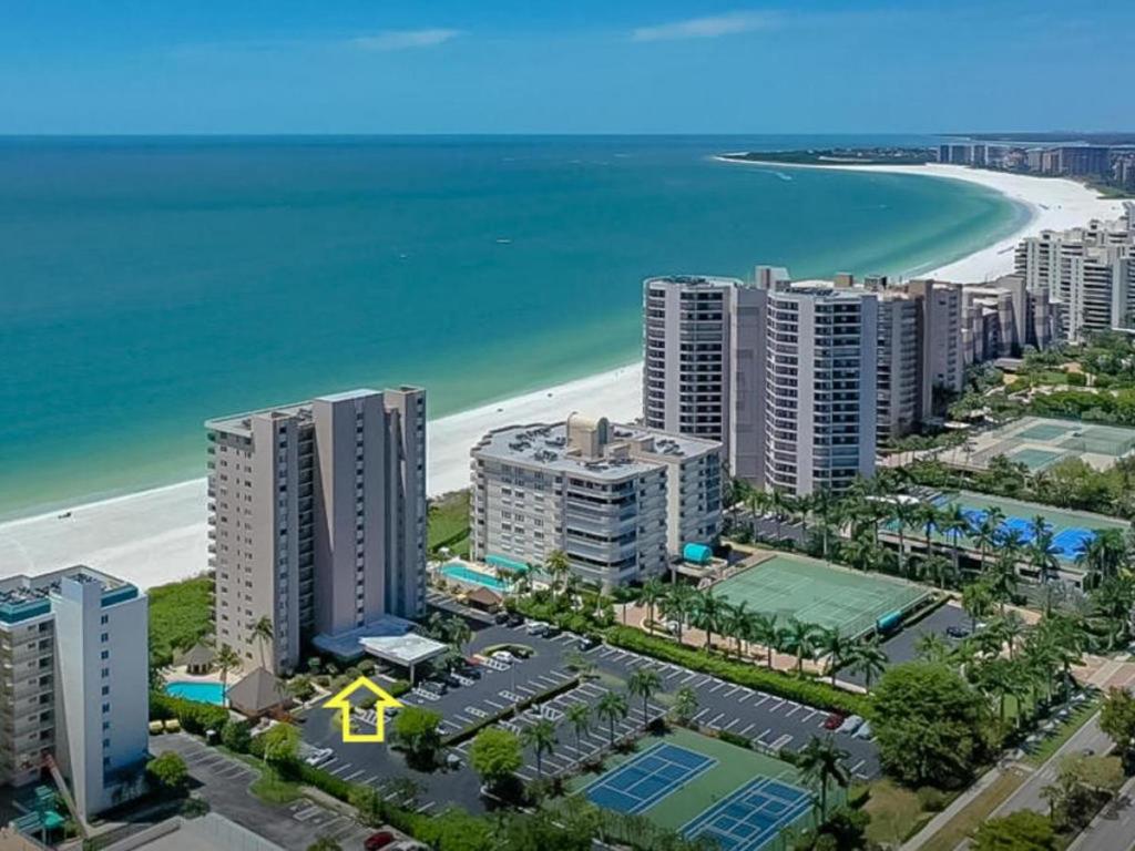 an aerial view of a beach with buildings and the ocean at Beachfront 2 Bed at Popular Seawinds!!! in Marco Island