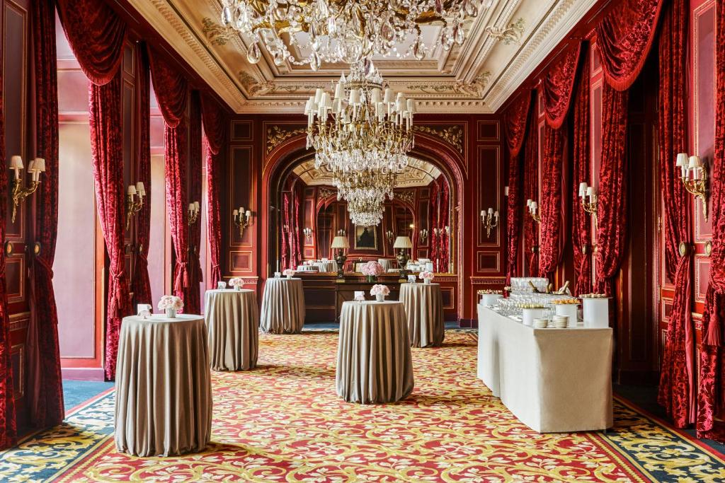 a ballroom with tables and a chandelier at InterContinental Paris Le Grand by IHG in Paris