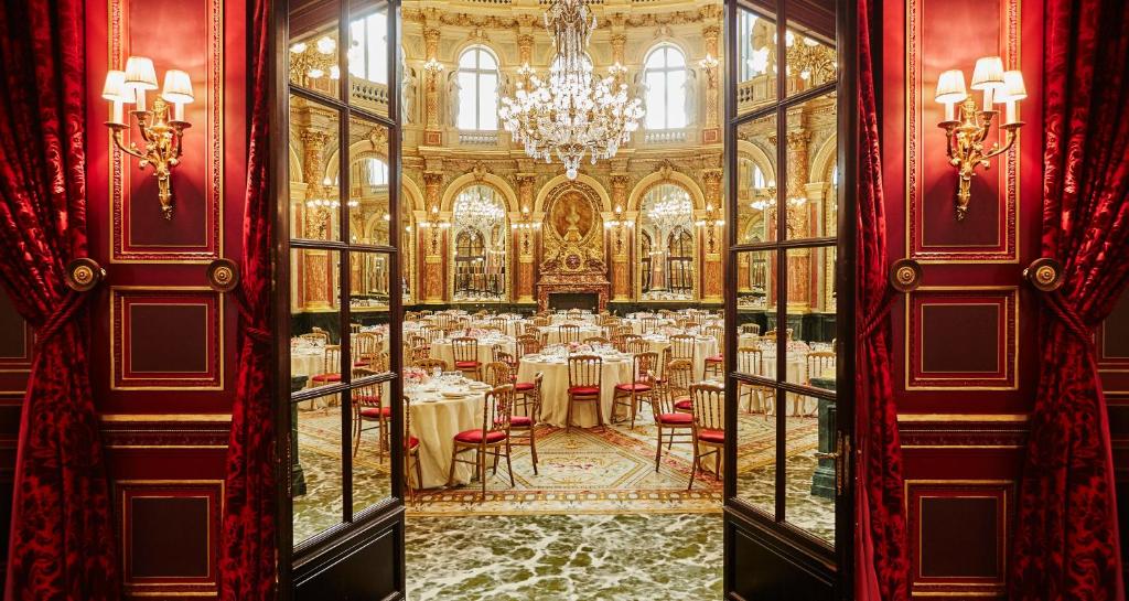 a dining room with tables and chairs in a building at InterContinental Paris Le Grand by IHG in Paris