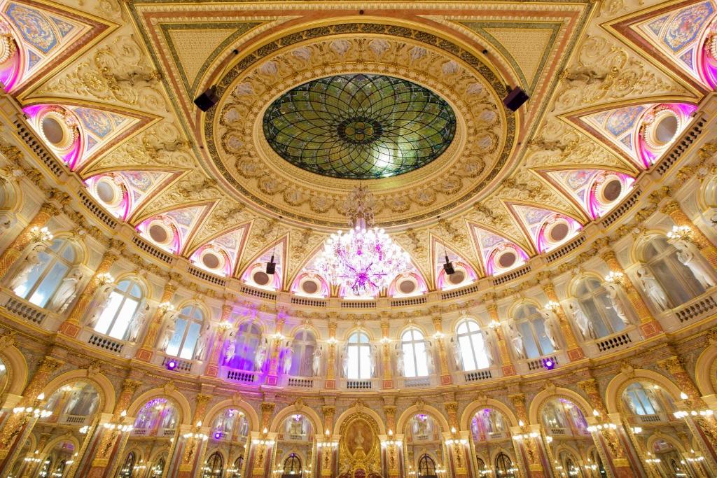 a large building with a ceiling with a chandelier at InterContinental Paris Le Grand by IHG in Paris