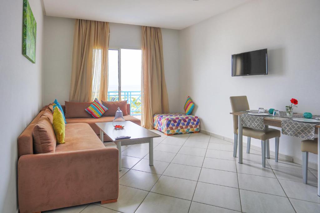 TV a/nebo společenská místnost v ubytování L'escale Appart-hôtel By 7AV HOTELS