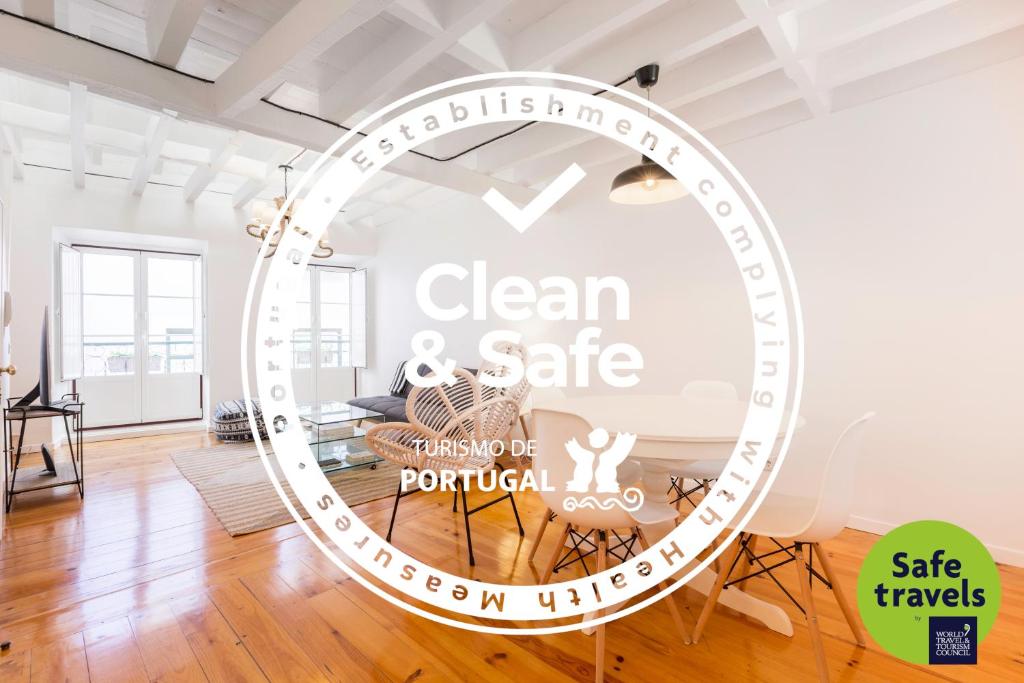a large mirror in a room with a sign that reads clean and safe at Stylish Getaway in a Mezzanine Flat by the Castle in Lisbon