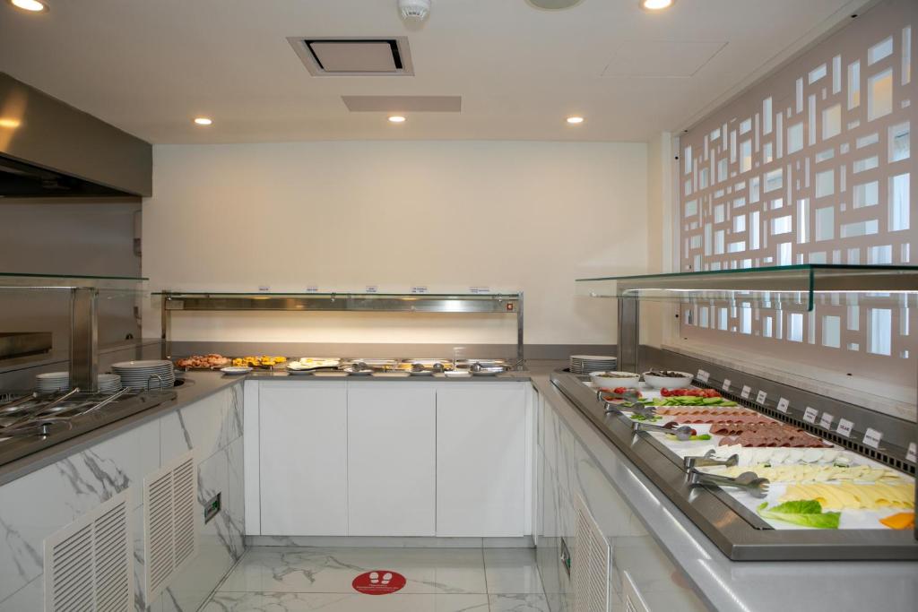 a kitchen with a buffet of food on display at Best Western Plus Larco Hotel in Larnaka