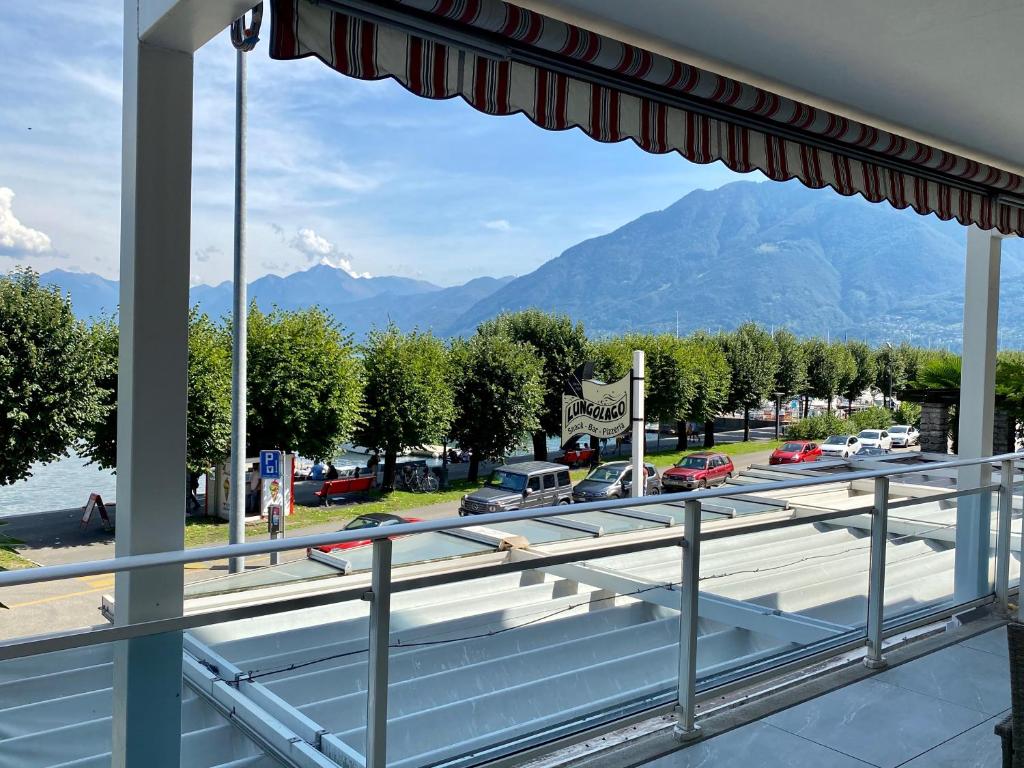 a balcony with a view of a road and mountains at Lungolago Rosso in Locarno