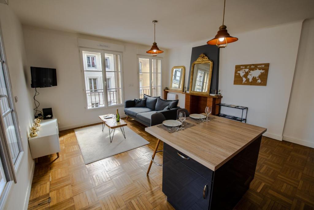 a living room with a couch and a table at Grand F2 refait à neuf, Plein coeur Centre Ville in Coutances