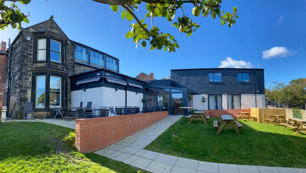 an exterior view of a house with a patio at Lairds House in Bedlington