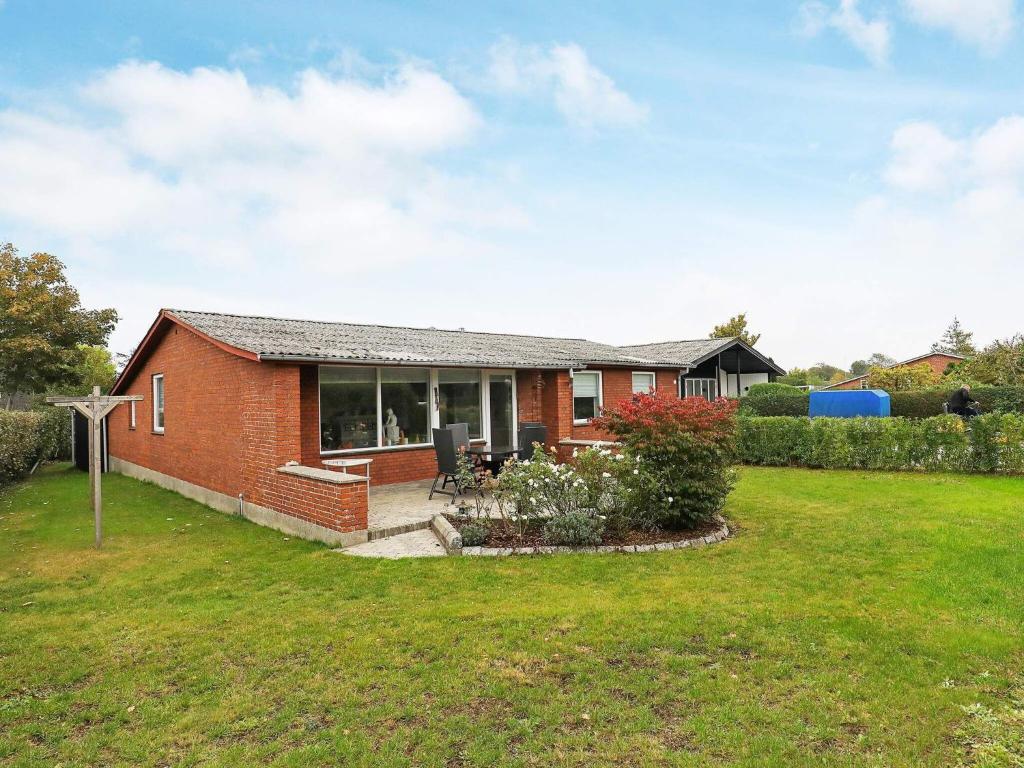 a red brick house with a yard at 6 person holiday home in r sk bing in Ærøskøbing