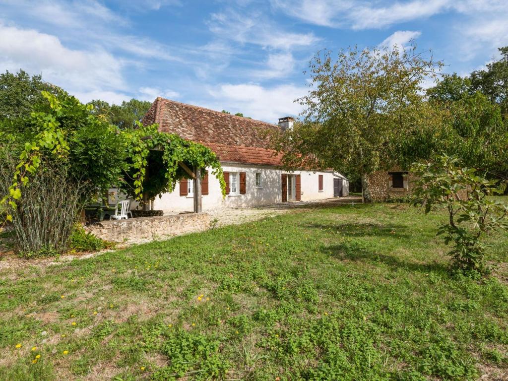 an old farmhouse with a yard in front of it at Holiday home in Cendrieux with garden shed in Cendrieux
