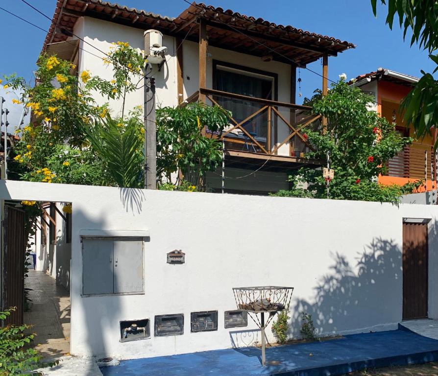 a white house with a basketball hoop in front of it at La Perla in Pipa