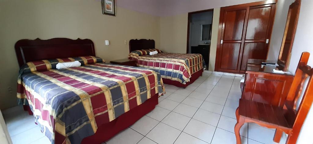 Postel nebo postele na pokoji v ubytování Hotel San Miguel