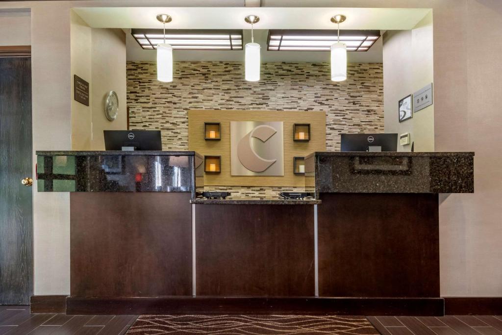 a lobby with a reception desk with two laptops on it at Comfort Inn & Suites Butler in Butler