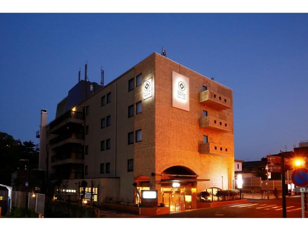 a large building with a clock on the front of it at Hotel OBANA in Nara