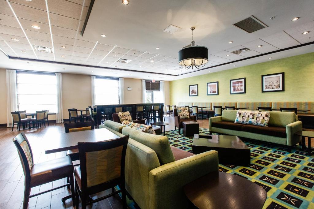 a waiting room with couches and tables and chairs at Holiday Inn Express & Suites Spruce Grove - Stony Plain by IHG in Spruce Grove