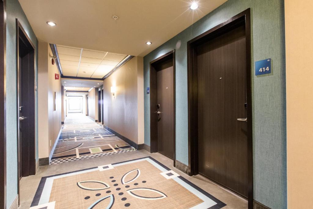a corridor of an office with a door and a carpet at Holiday Inn Express & Suites Spruce Grove - Stony Plain by IHG in Spruce Grove