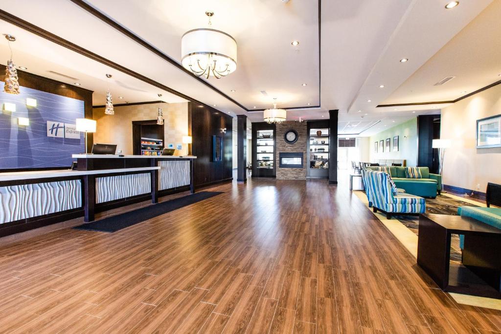 a large lobby with wooden flooring and a waiting room at Holiday Inn Express & Suites Spruce Grove - Stony Plain by IHG in Spruce Grove
