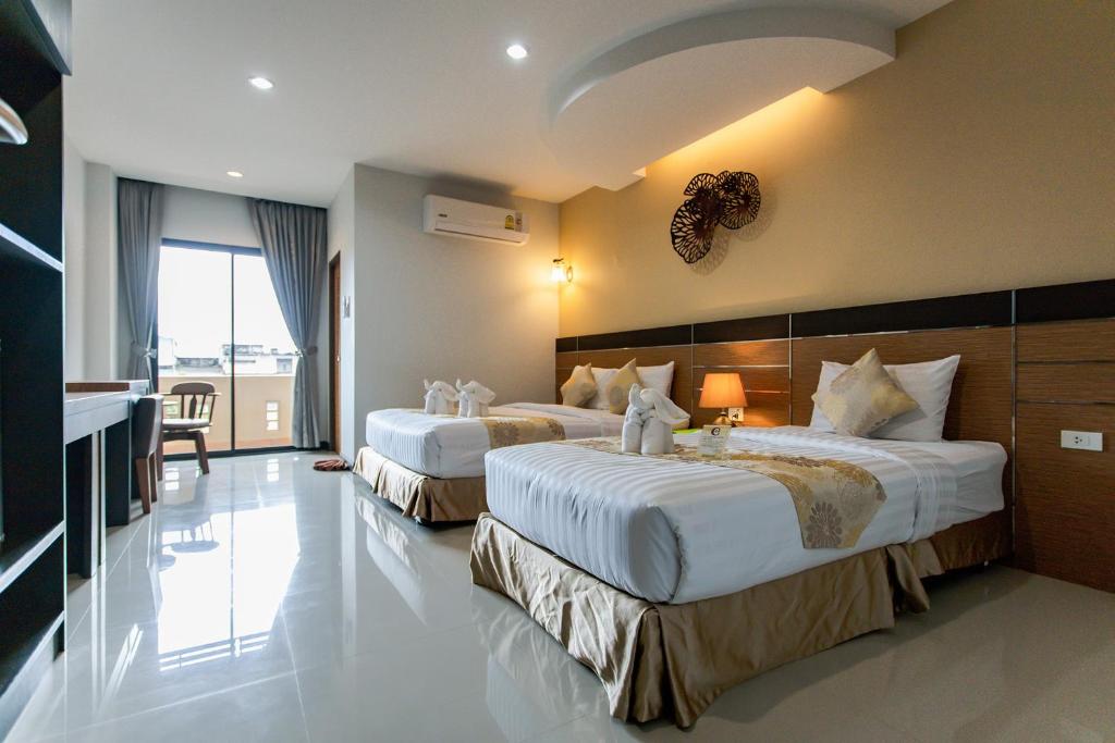 Cama o camas de una habitación en The Centris Hotel Phatthalung