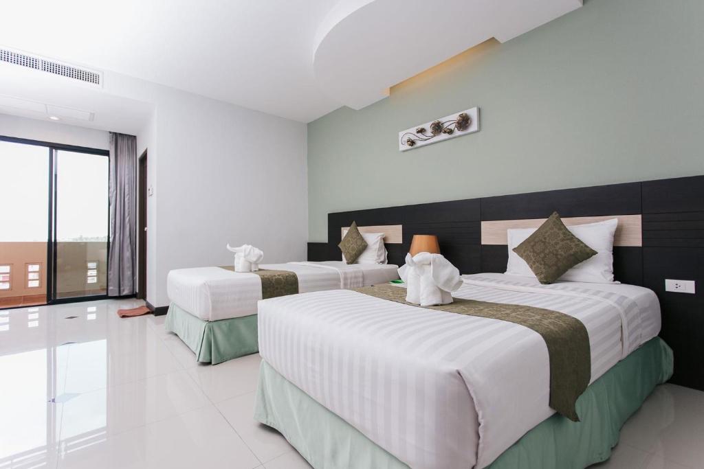 Cama o camas de una habitación en The Centris Hotel Phatthalung