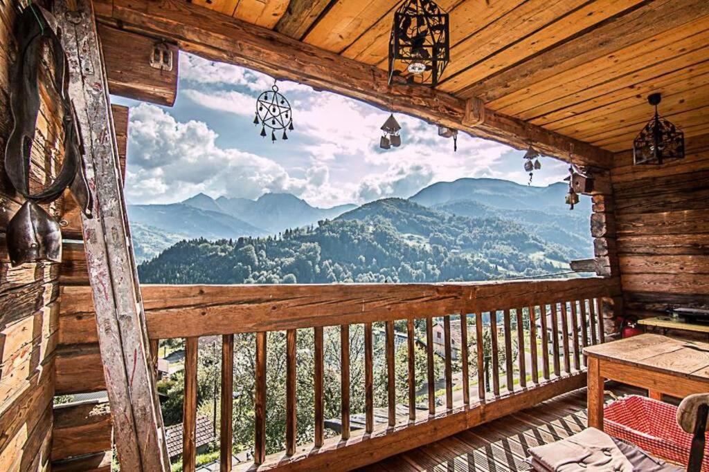 a view from a cabin balcony with a view of mountains at Beautiful, atypical loft in the Aravis in Les Clefs