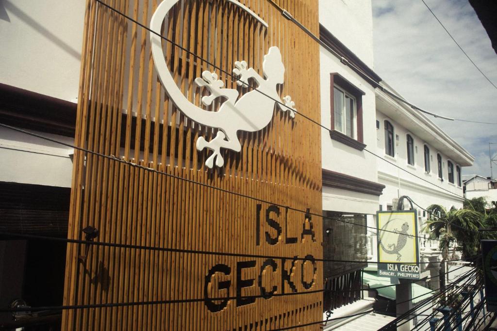 a sign on the side of a building at Isla Gecko Resort in Boracay