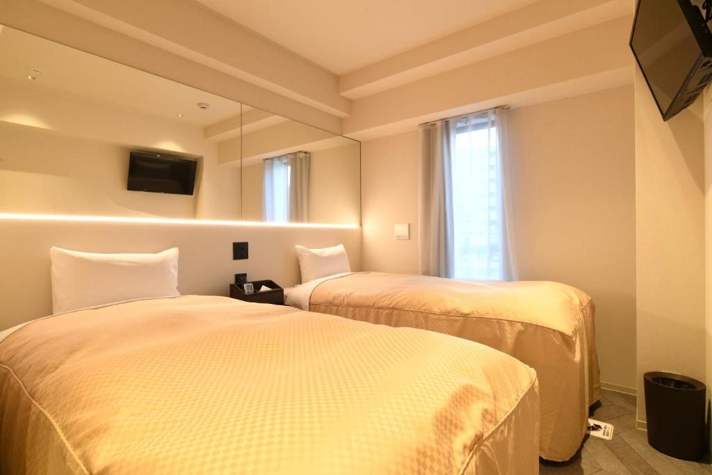Postel nebo postele na pokoji v ubytování Hotel Wisteria NARA