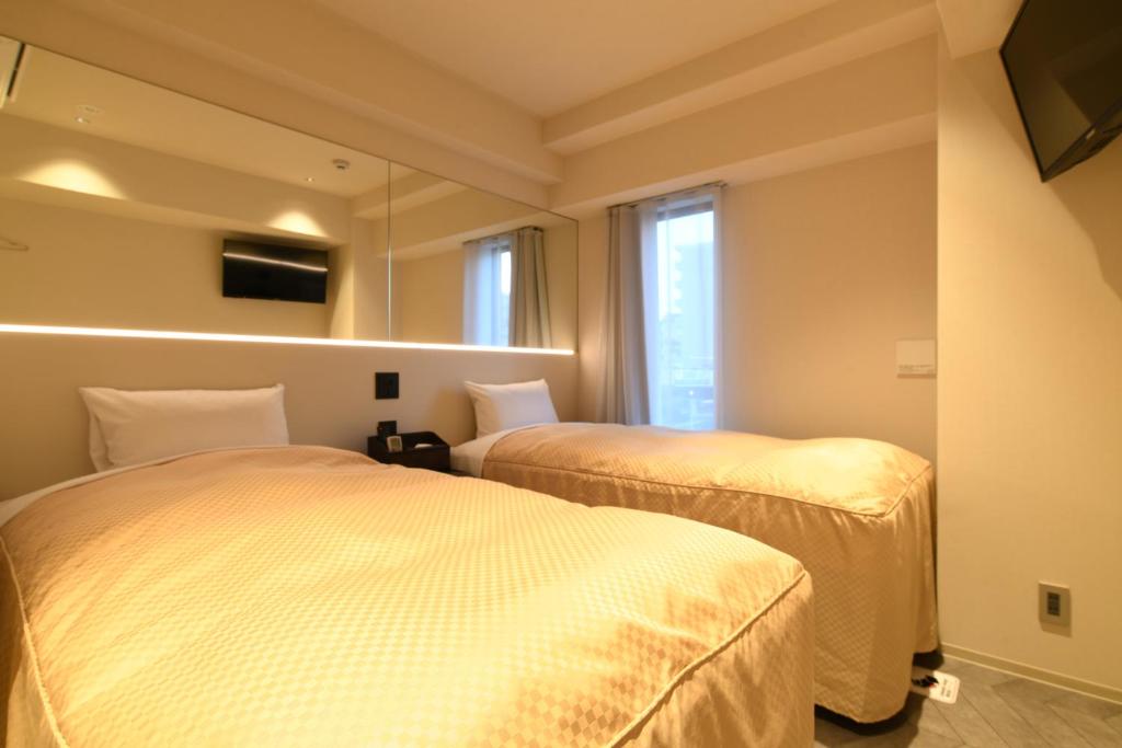 Postel nebo postele na pokoji v ubytování Hotel Wisteria NARA