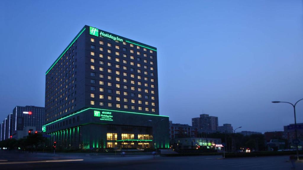 a tall building with green lights on top of it at Holiday Inn Beijing Deshengmen, an IHG Hotel in Beijing