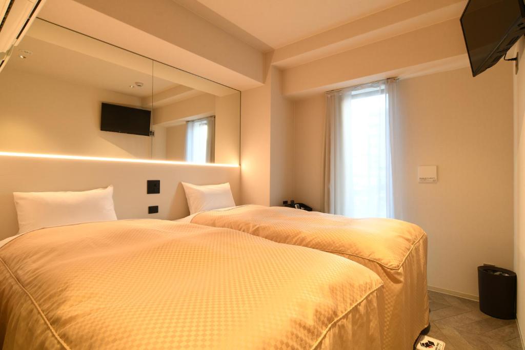 Postel nebo postele na pokoji v ubytování Hotel Wisteria NARA