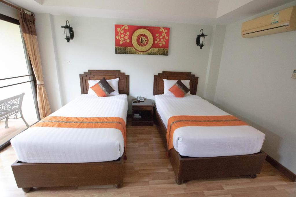 Uma cama ou camas num quarto em Luckswan Resort Chiang Rai - SHA Extra Plus