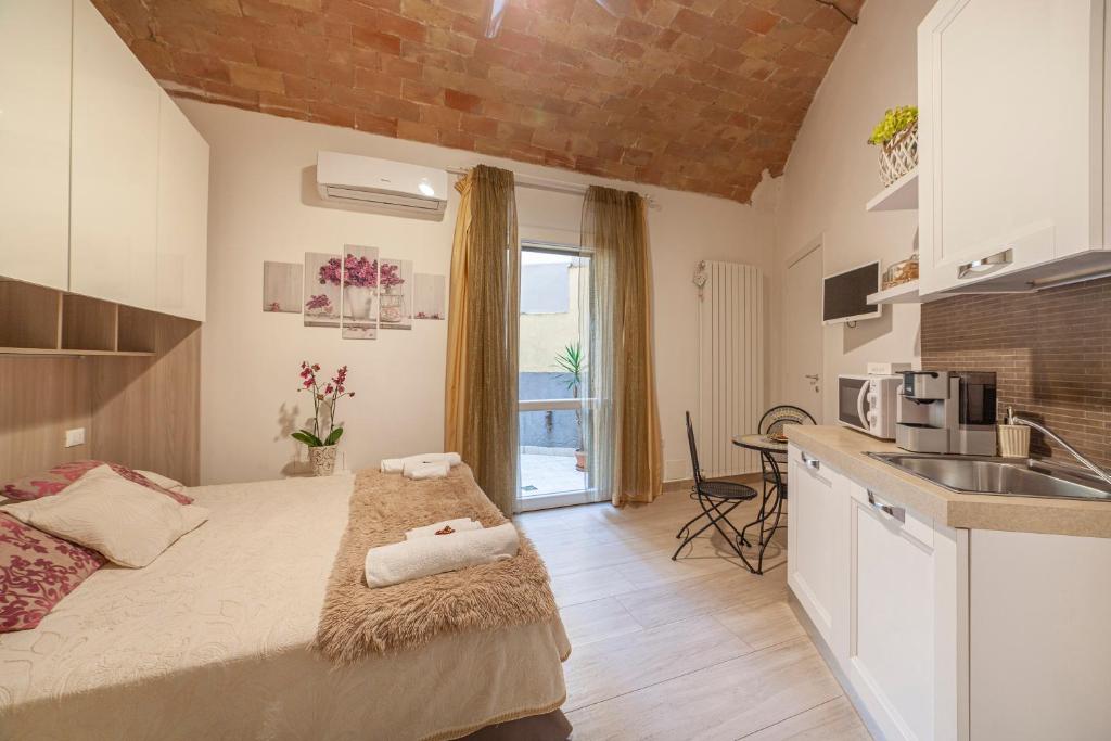 a bedroom with a bed and a kitchen with a sink at B&B Prima Dell'Elba in Piombino