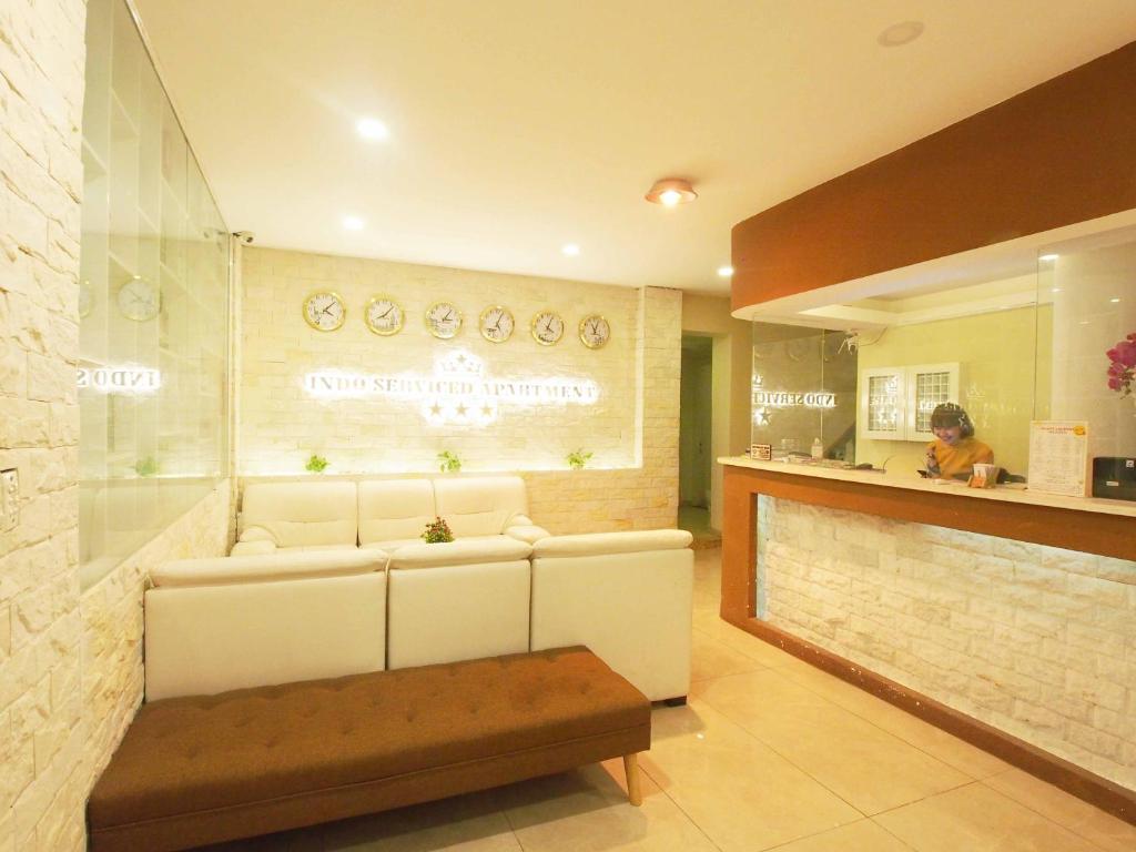 a living room with a white couch and a counter at INDO Serviced Apartment in Ho Chi Minh City