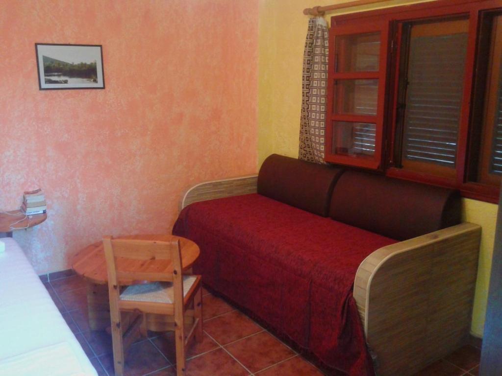 a small room with a couch and a table at Sunrise Apartments in Palekastron
