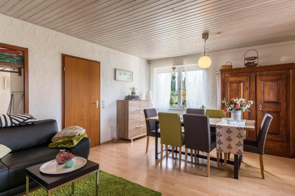 a living room with a table and a dining room at Appartement Böhler 1 in Reichenau