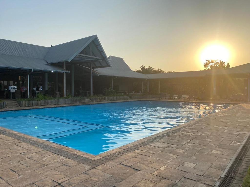 a large swimming pool in front of a building at Sands Beach Simbithi Eco Estate Luxury Villa in Ballito