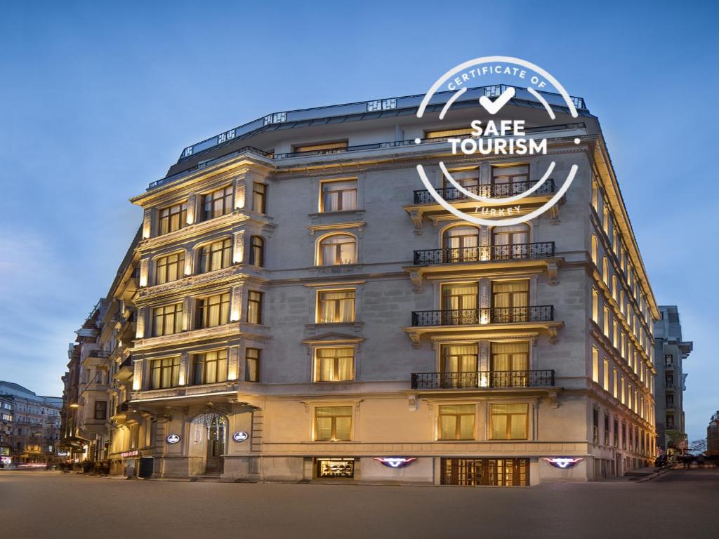 a large building with a clock on the side of it at AKKA Lush Hotel Taksim in Istanbul