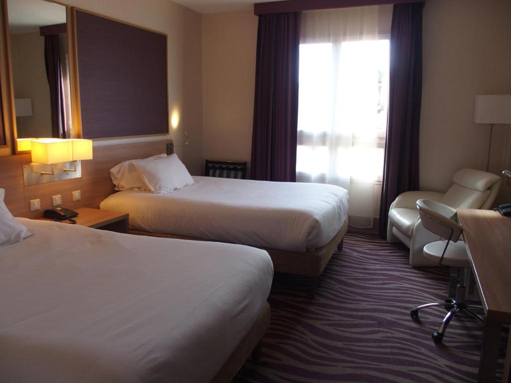 Postel nebo postele na pokoji v ubytování Plaza Hotel Capitole Toulouse