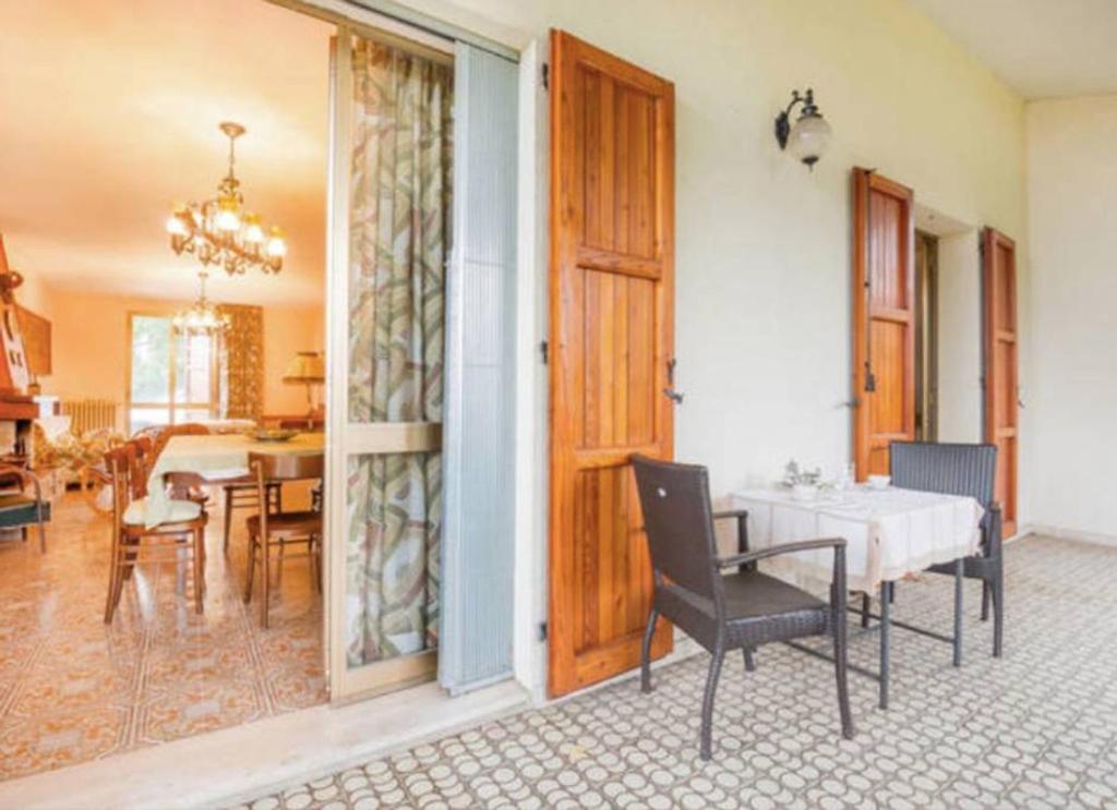 a room with a table and chairs and a dining room at 3 bedrooms house with furnished garden at Selve di Monzuno in Monzuno
