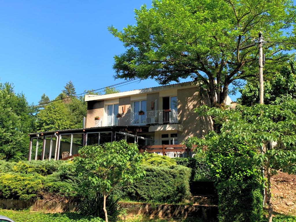 a house on a hill with trees in front of it at LE CANTEGREL in Teillet