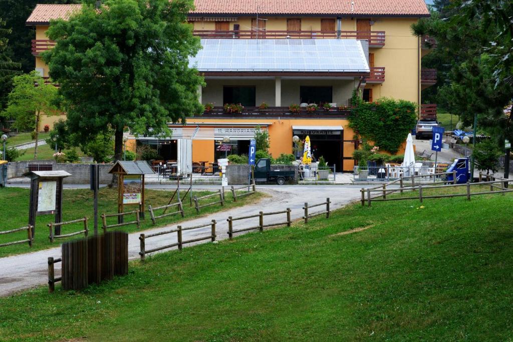 a building with a fence in front of a building at Il Mandriano in Carpegna