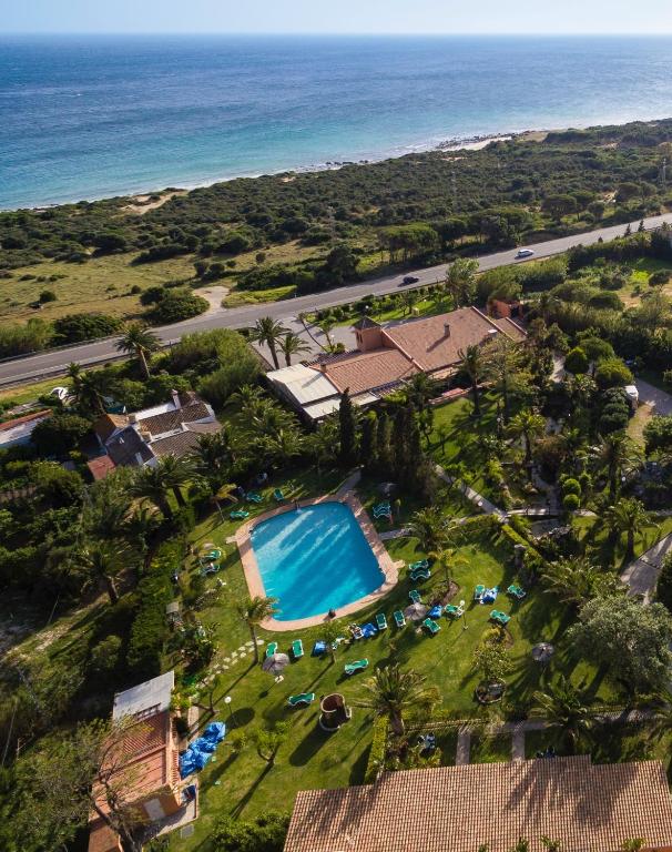 an aerial view of a resort with a swimming pool and the ocean at Hotel Punta Sur in Tarifa