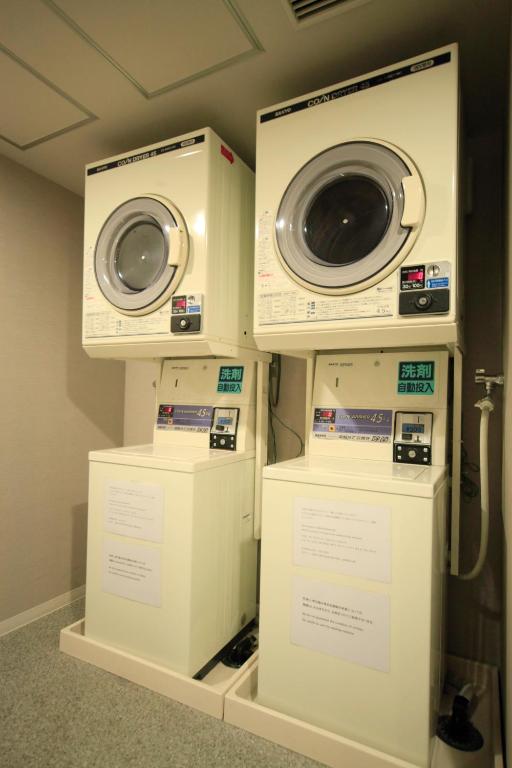 two washing machines are on display in a room at Sotetsu Fresa Inn Higashi Shinjuku in Tokyo