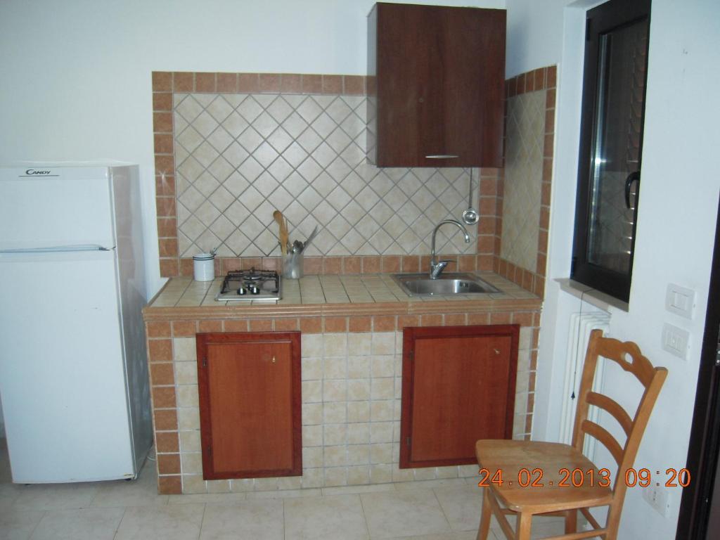 a small kitchen with a sink and a refrigerator at Residence Hotel Torresilvana in Vieste