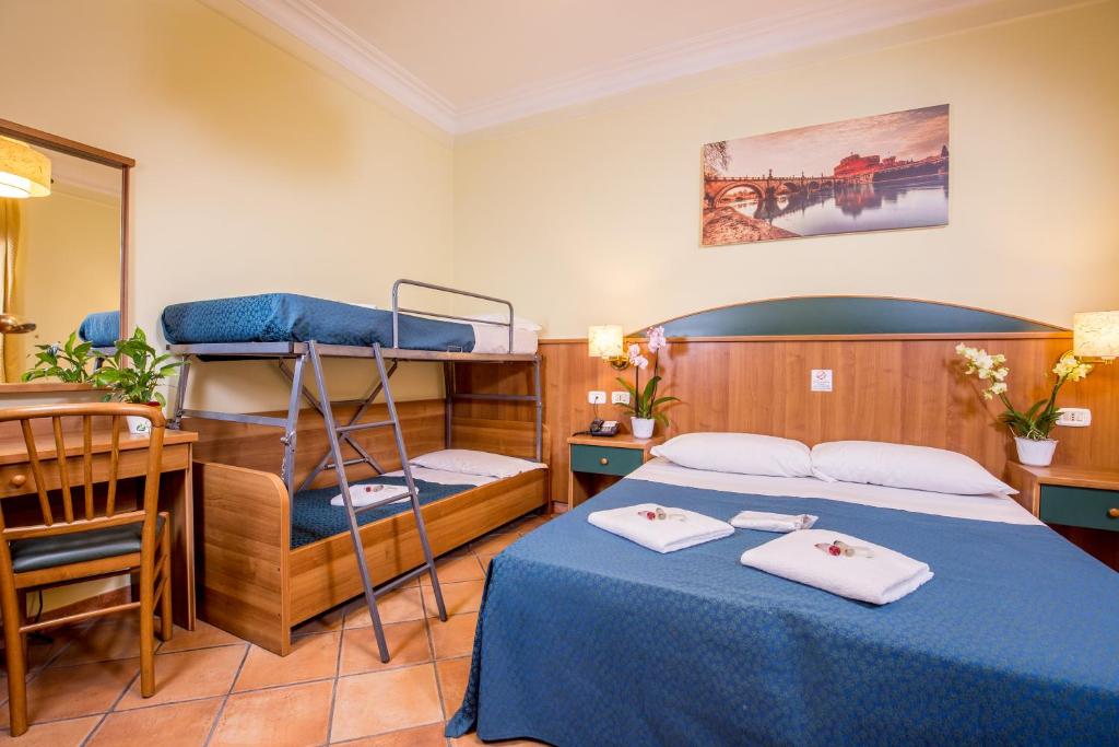 a bedroom with a bed and a desk and a bunk bed at Hotel Trastevere in Rome