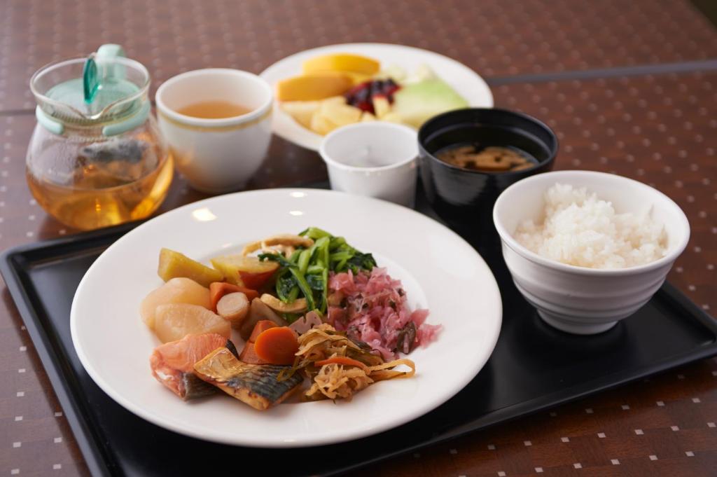 a plate of food on a tray with rice at Sotetsu Fresa Inn Higashi Shinjuku in Tokyo
