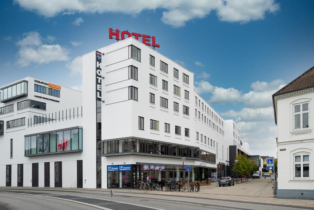 a white building with a hotel sign on top of it at Cabinn Aalborg in Aalborg