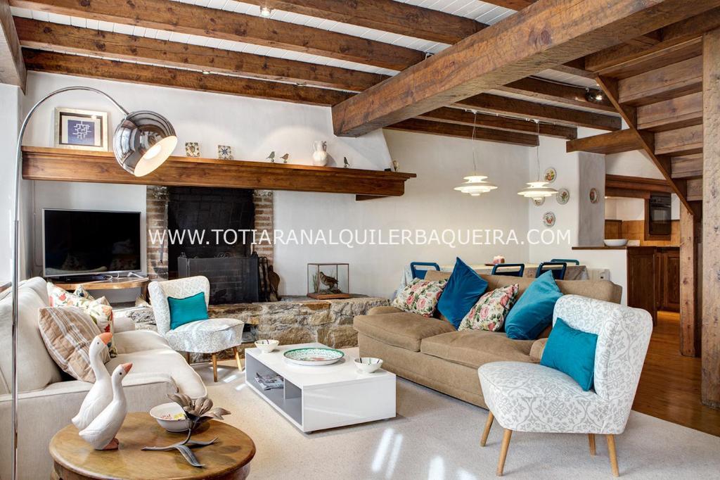 a living room with a couch and chairs and a fireplace at Casa Er Os by Totiaran in Baqueira-Beret