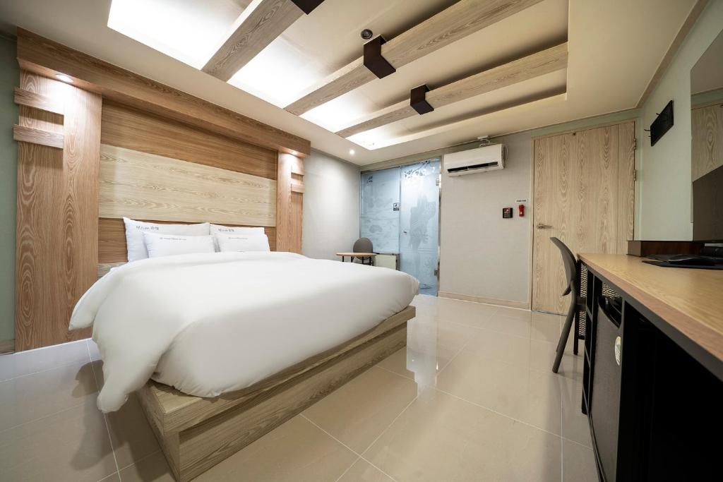 Postel nebo postele na pokoji v ubytování Suwon Sunstar Hotel