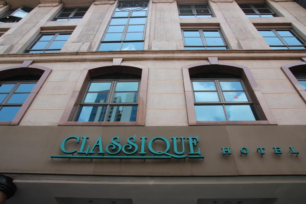 a sign on the front of a building at Classique Hotel in Singapore